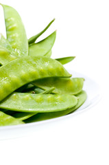 Green peas on plate close up