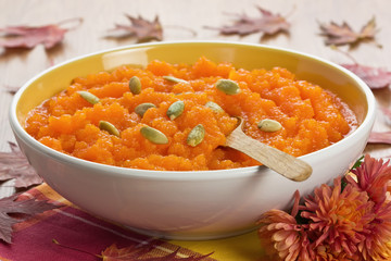 Pumpkin soup with seeds in ceramic bowl shallow DOF