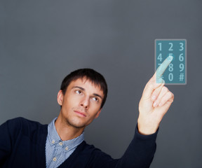 Portrait of adult business man pressing a touchscreen button whi