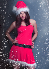 Portrait of beautiful young christmas woman posing wearing santa