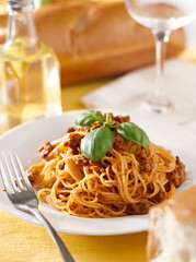 spaghetti with basil garnish in meat sauce