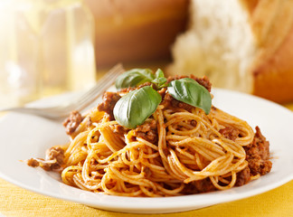spaghetti with basil garnish in meat sauce