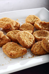 breaded chicken nuggets on a plate.