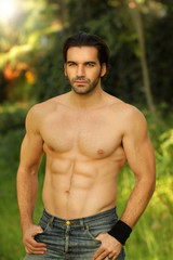 Outdoor portrait of a shirtless good looking fit male model