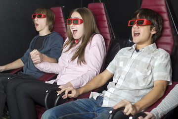 A group of  teenagers sits in the 3-D cinema