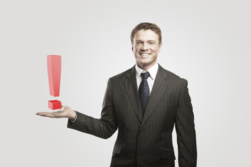 Young  businessman with an exclamation mark on his hand