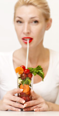 Concept image of a woman holding a glass of vegetables