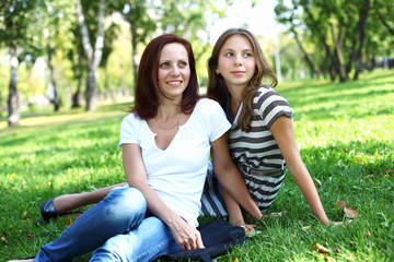 Mother with her daughter in summer park