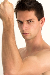 Naklejka premium Man showing he's arm muscles and smiling