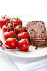 Grilled beefsteak with cherry tomatoes on the vine
