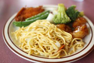 Chinese Chow mein with vegetables and sides.