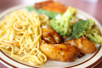 Chinese Chow mein with vegetables and sides.