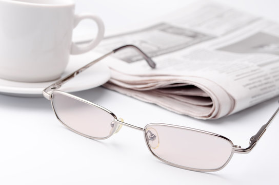 Eyeglass and newspaper