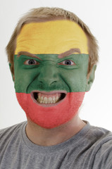 Face of crazy angry man painted in colors of lithuania flag