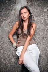 Happy young model next to concrete.