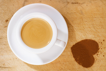 espresso coffee in thick white cup with cocoa heart