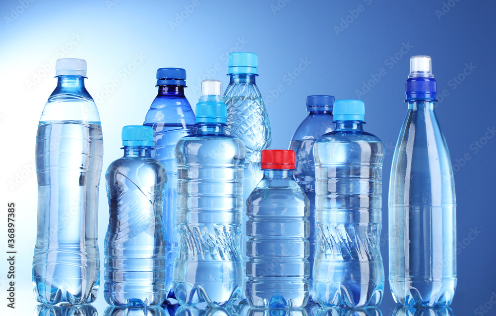 Wall mural Group plastic bottles of water on blue background - Wall murals