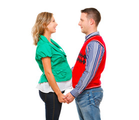 Smiling pregnant woman with husband looking on each other