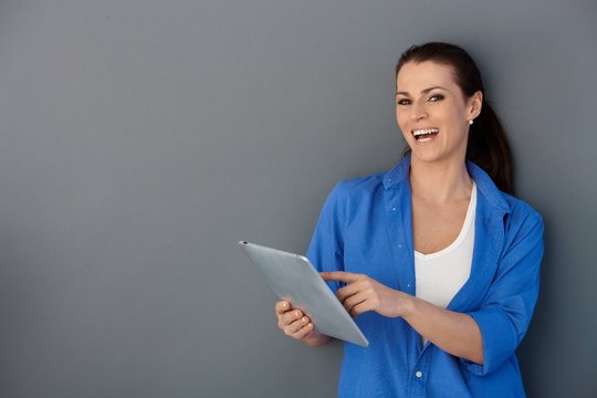 Laughing woman with touchscreen pad