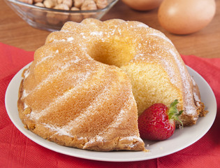 sliced cake with a strawberry and knife