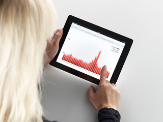 Blonde woman doing analysis on her tablet pc