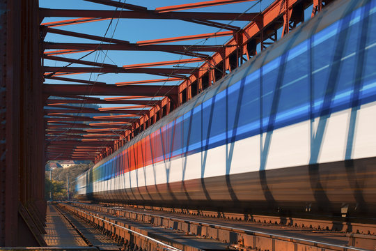 Fototapeta The express train on the old iron bridge