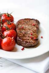 Grilled beefsteak with cherry tomatoes on a plate