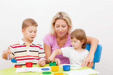 Fototapeta premium brother and the sister draw finger-type paints