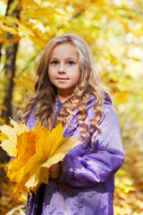 beautiful little girl on walk in autumn park