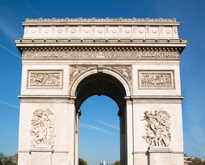 Triumphal arch in Paris against a backdrop of blue sky , France