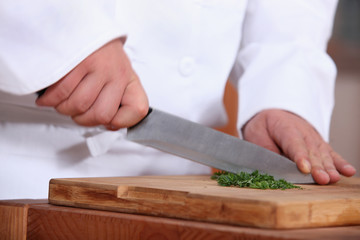 Chef chopping parsley