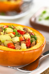 Baked pumpkin with zucchini, bell pepper, minced meat, onions