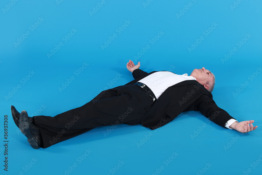 Wall mural man lying against blue background