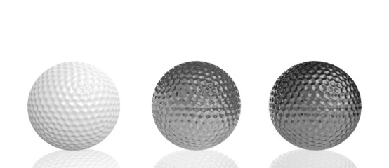 three golf balls of different materials