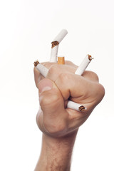 Man's hand crushing cigarettes