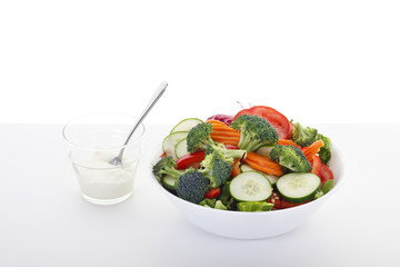 Vegetable Salad with Dressing on White Table