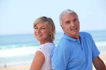happy senior couple on the beach