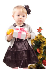 Little girl with Christmas tree and gifts
