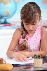 little girl drawing at school