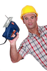 craftsman holding an electric saw