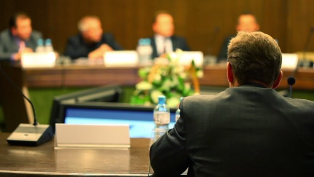 Man in business suit sit at the table on conference