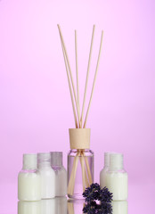 Obraz na płótnie Canvas air freshener, bottles and lavander on pink background