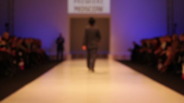 Man wear suit and top hat from walk the catwalk, out of focus