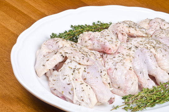 Raw Cornish Game Hens On A White Plate