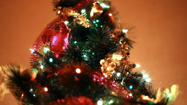 christmas tree lit colorful lights on background wall