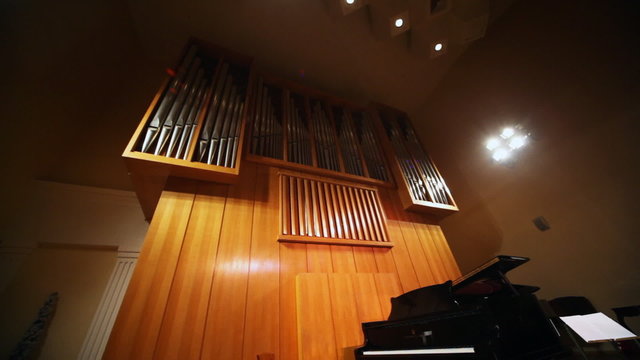grand piano on stage near organ, panorama from bottom up