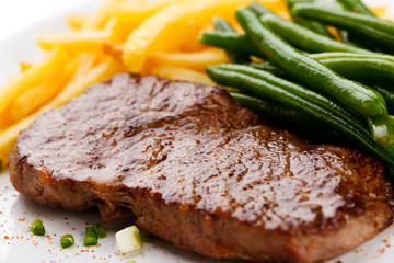 Grilled steak, French fries and green beans