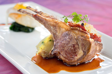 Seared and roasted lamb ribs with baked potato