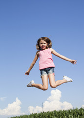 Fototapeta na wymiar young girl exercising jumping in the air