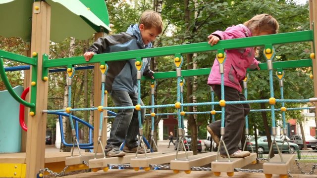 Little girl and boy jump hang down steps